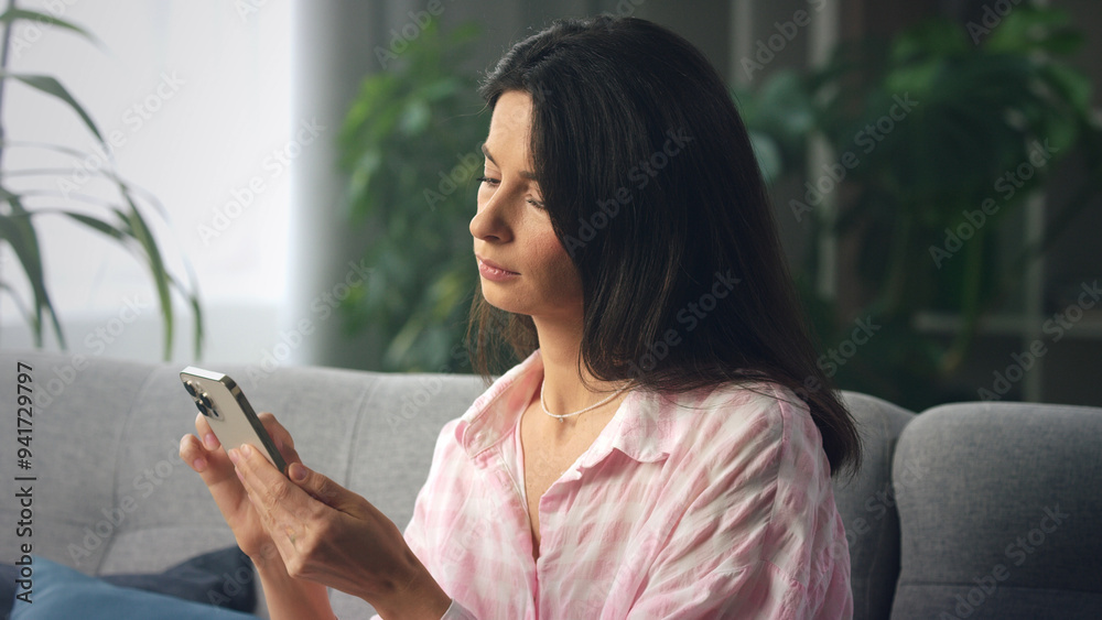 Young woman using smartphone while relaxing on Young woman using smartphone while relaxing on