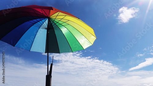 Closeup of a colorful umbrella opened against sunlight
