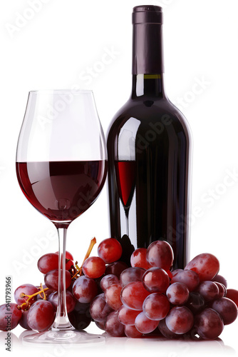 Bottle, filled glass of red wine and bunch of grapes on white background