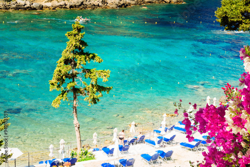 Fototapeta Naklejka Na Ścianę i Meble -  Paleokastritsa beach bay with sunbeds and Ionian sea clear water on Korfu, Greece