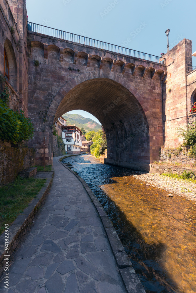 Quaint village under an ancient bridge in Potes, Cantabria Quaint village under an ancient bridge in Potes, Cantabria