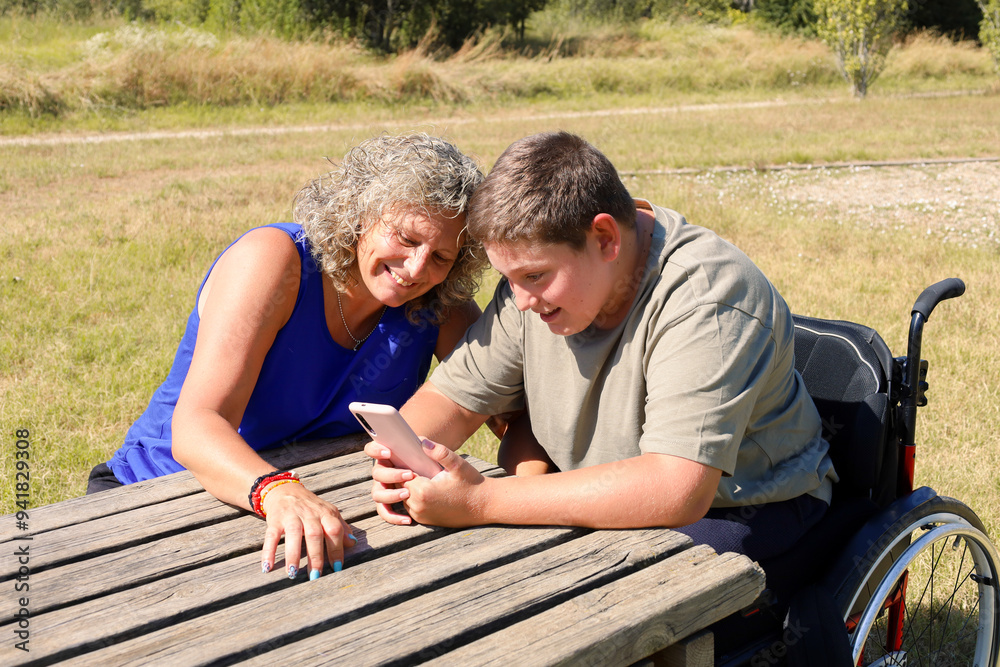 Boy with disability sharing moments with a friend outdoors Boy with disability sharing moments with a friend outdoors