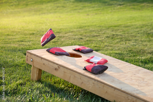 Fototapeta Naklejka Na Ścianę i Meble -  backyard game of cornhole, bags on the board 