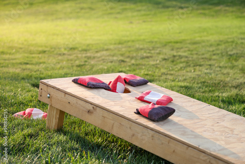 Red cornhole bag entering goal hole photo