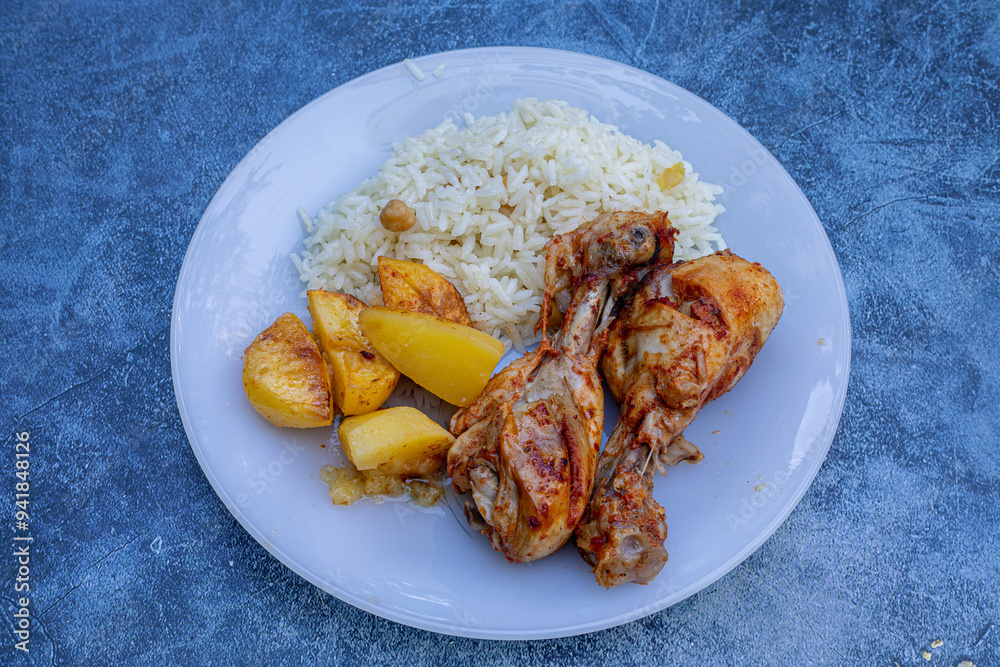oven-fried chicken legs, french fries and rice pilaf.