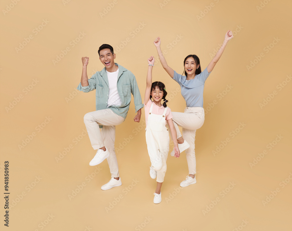 Obraz premium Portrait happy smiling Asian family celebrate winner together isolated on nude color background.