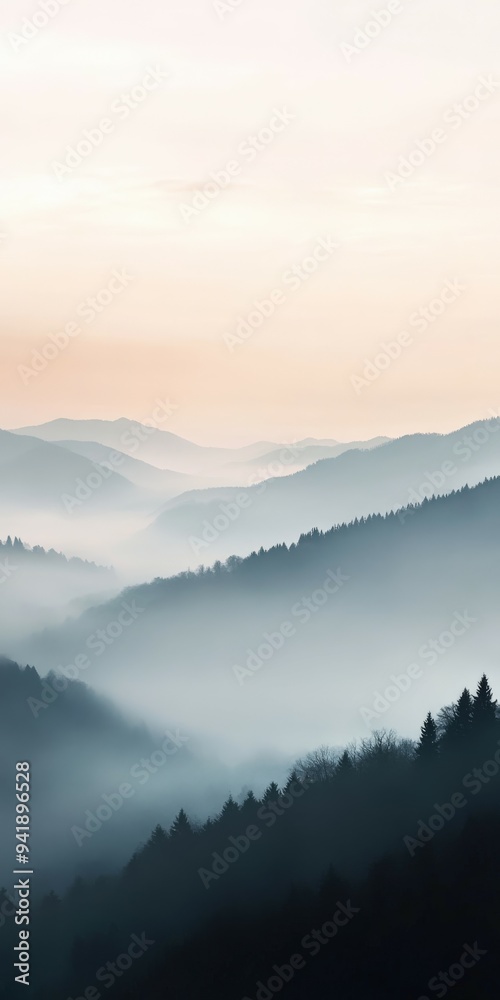 Fototapeta premium Misty mountain landscape at dawn with a soft pastel sky in the distance
