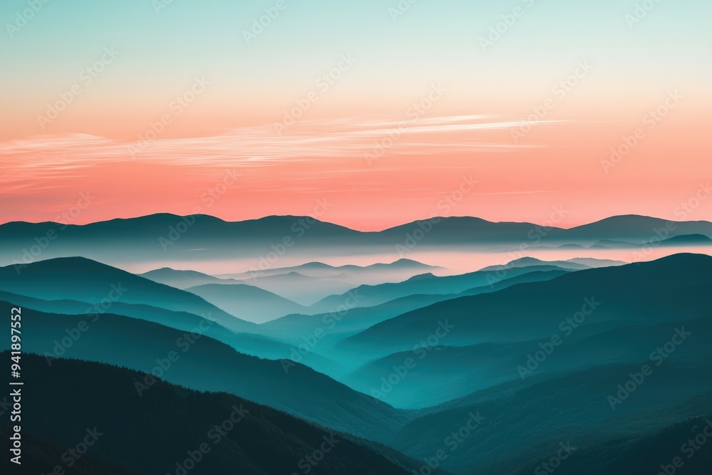 Obraz premium Serene sunrise over misty mountain ranges at dawn