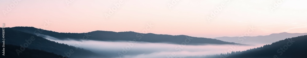 Fototapeta premium Misty mountains at dawn with soft hues and serene landscape views