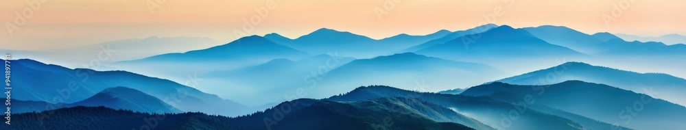 Obraz premium Serene mountain landscape at dawn with soft, misty blue hues