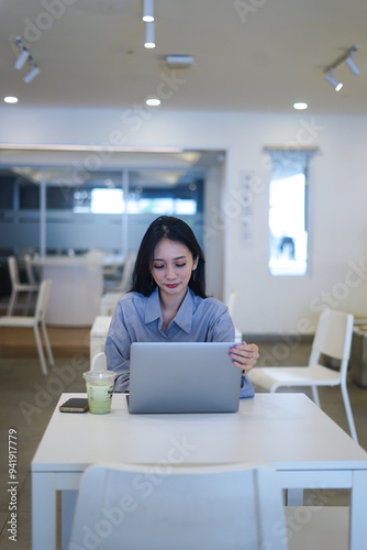 Businesswoman works at laptop waving hello having video call with client at office Remote job