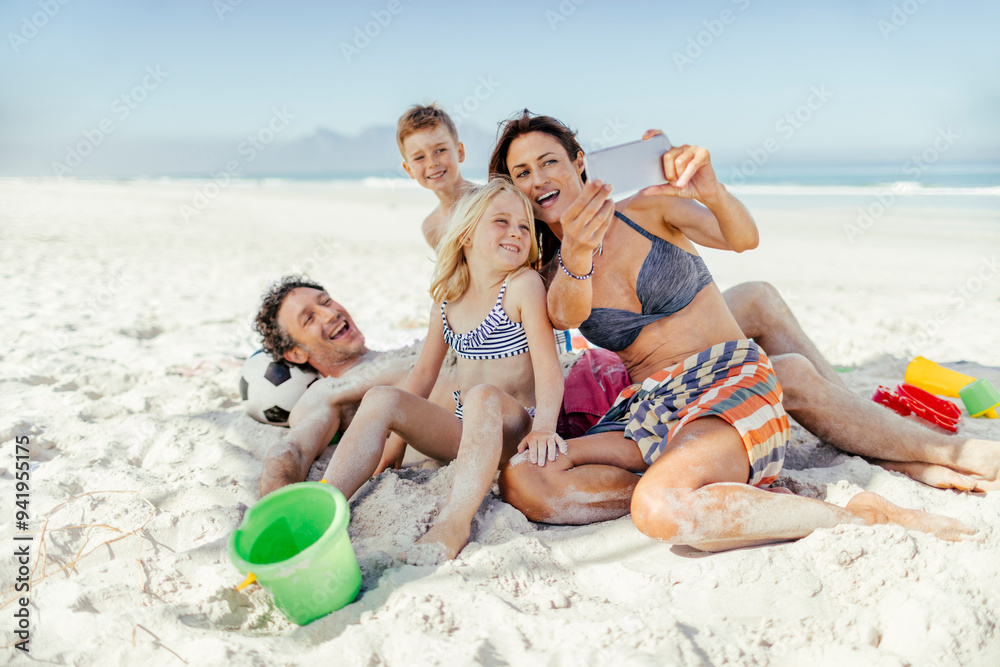 Family having fun at the beach and taking pictures Family having fun at the beach and taking pictures