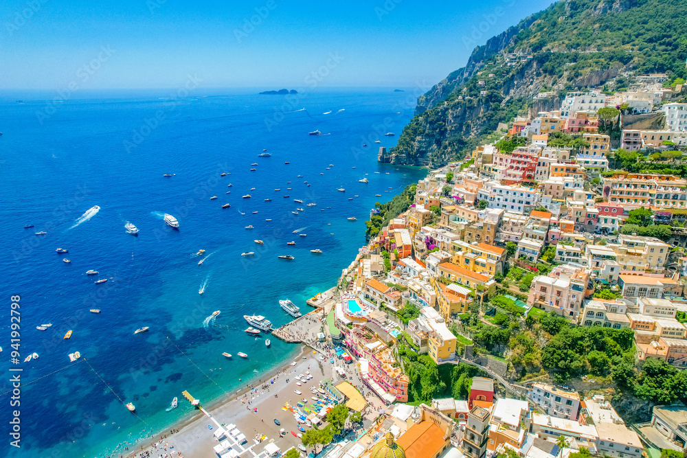 Naklejka premium Positano town, beach and beautiful colorful houses on the cliff in Amalfi coast in Italy
