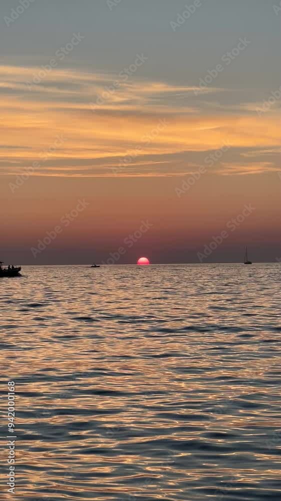 Vertical sea scenery with sunset and ships. Sunset horizon. Golden waves relaxing motion. Sunset background. Filmmaking wallpapers Vertical sea scenery with sunset and ships. Sunset horizon. Golden waves relaxing motion. Sunset background. Filmmaking wallpapers