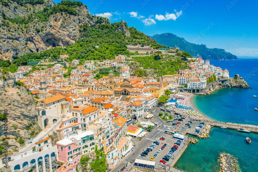Naklejka premium Amalfi on Amalfi Coast, Italy. Aerial photo of famous city Amalfi located on Amalfi Coast with blue sea water and beautiful colorful houses on the cliff