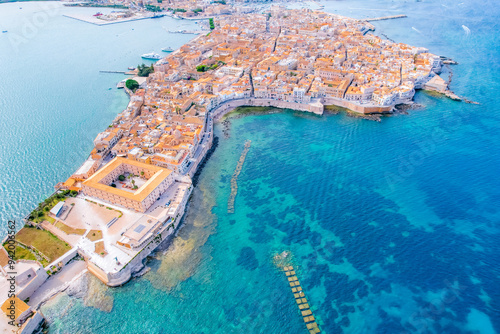 Aerial of Ortigia island, old town with turquoise sea of Syracuse. Small island on Sicily, Italy. photo