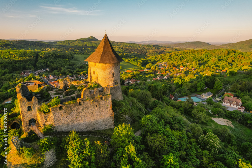 Naklejka premium Ruins of a medieval castle Somoska or Somoskoi var on borders of southern Slovakia and Hungary at sunrise time. .Salgo Castle or Salgo vara in background