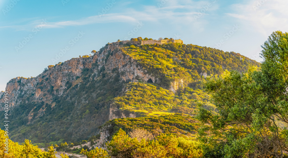 Voidokilia beach, lagoon with beaches in mediterranean, Ionian Sea, Pylos town , Greece. Navarino Castle on hill.