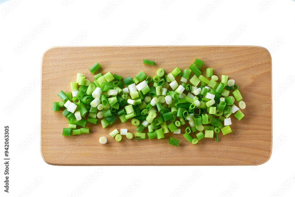 Chopped young green onions on a cutting board , isolated on a white background. Top view. Chopped young green onions on a cutting board , isolated on a white background. Top view.