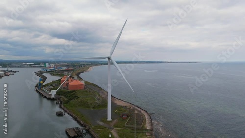 Drone video of wind turbine on a river bank