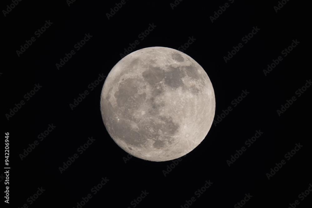 photograph of the full moon partially covered with clouds photograph of the full moon partially covered with clouds