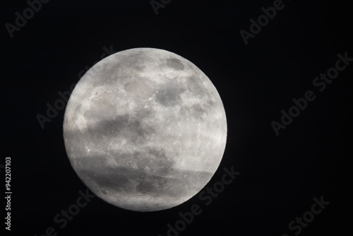 Obraz na plátně photograph of the full moon partially covered with clouds