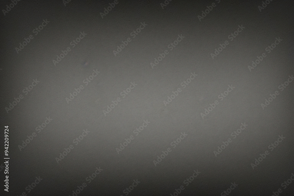 Black background made of real, shiny black paper covered with foil, illuminated by a soft light from above. Black background made of real, shiny black paper covered with foil, illuminated by a soft light from above.