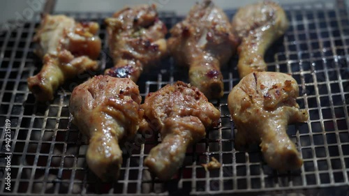 Home barbecue on charcoal grill, man turning chicken drumsticks on grill, Mahe Seychelles. 25 fps 1 photo