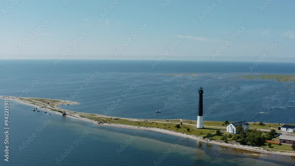 Flying around Sorve lighthouse at the tip of Saaremaa island revealing infinite views of Baltic sea. Aerial coastline view. Flying around Sorve lighthouse at the tip of Saaremaa island revealing infinite views of Baltic sea. Aerial coastline view.