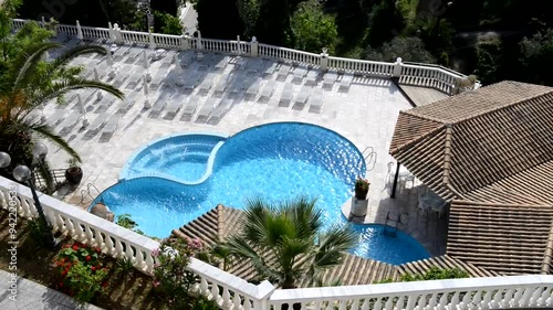 Panning up from the swimming pool and jacuzzi at luxury hotel. At the end is a view on a bay and beach and sound of birds. Corfu island, Greece