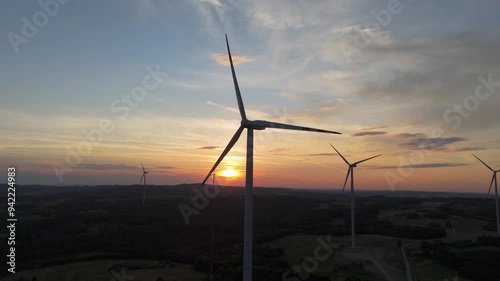 Scenic Aerial view of wind turbines farm in sunset time. Wind turbine producing alternative energy