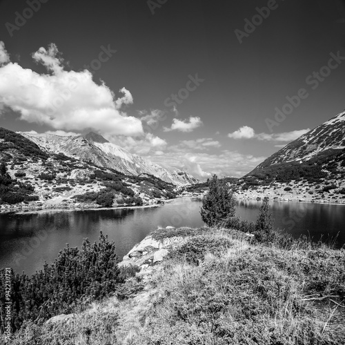 Black and White landscape in Pirin mountains. Banderishko Ribno lake against Hvoinati and Vihren peaks. photo