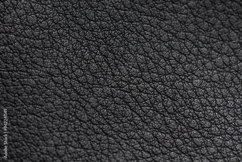 Black leather material texture for use as background.