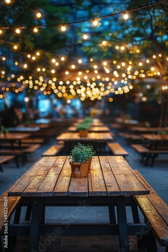 Cozy outdoor dining area illuminated by string lights in a vibrant urban sett...