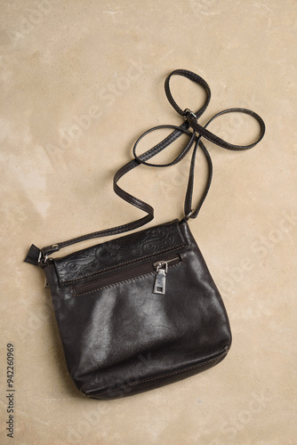 Brown genuine leather bag on beige background