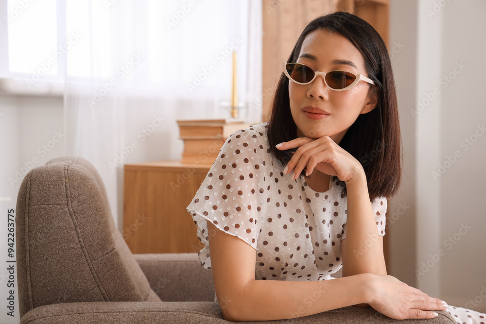 Beautiful Asian woman in stylish sunglasses at home Beautiful Asian woman in stylish sunglasses at home