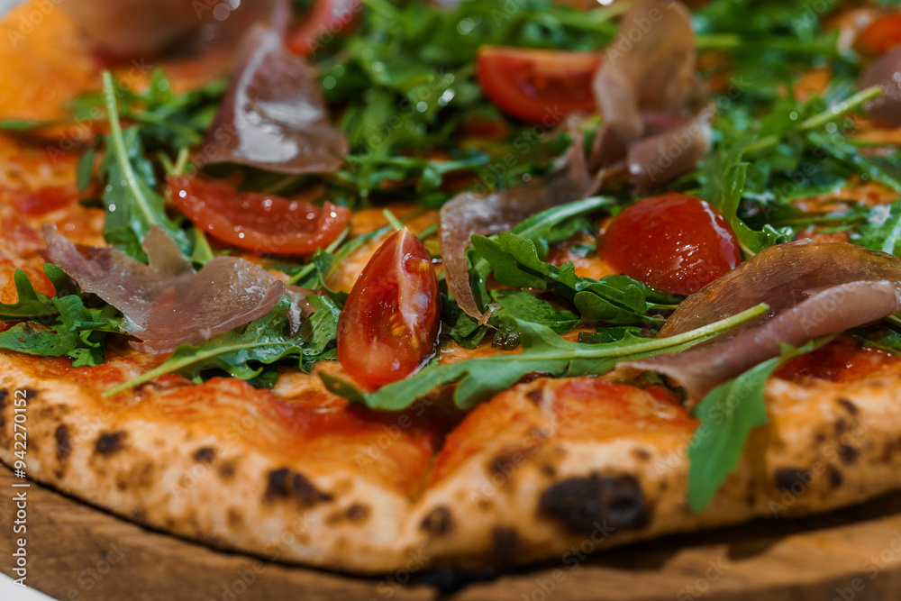Pepperoni pizza with arugula and prosciutto. Meat pizza with cheese, cherry tomatoes and fresh arugula on a white background Pepperoni pizza with arugula and prosciutto. Meat pizza with cheese, cherry tomatoes and fresh arugula on a white background