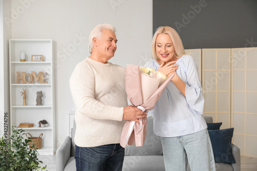 Mature man giving his wife ...