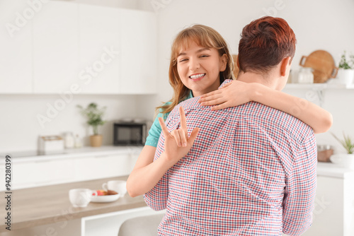 Young deaf mute woman huggi...