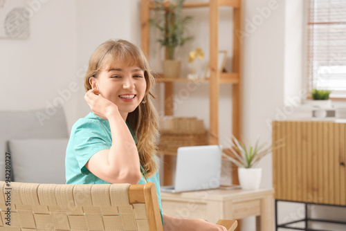 Young woman with hearing ai...