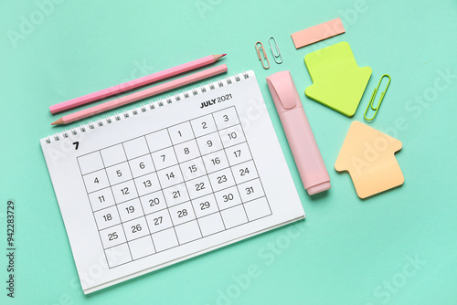 Calendar with office stationery on turquoise background