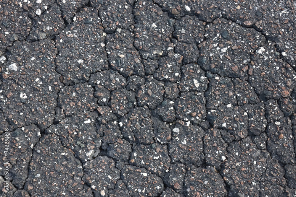 Cracked Asphalt Closeup with Imbedded Stones