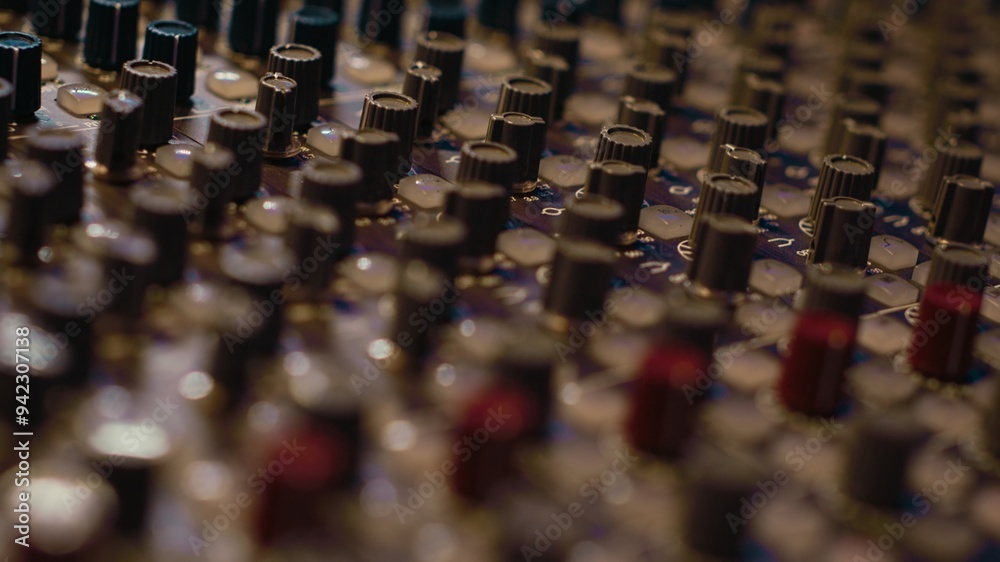 Pre amp knobs and switchers on mixing console panel board, audio stereo equipment used in music post production. Empty control room in professional studio, fader and sliders. Close up. Pre amp knobs and switchers on mixing console panel board, audio stereo equipment used in music post production. Empty control room in professional studio, fader and sliders. Close up.