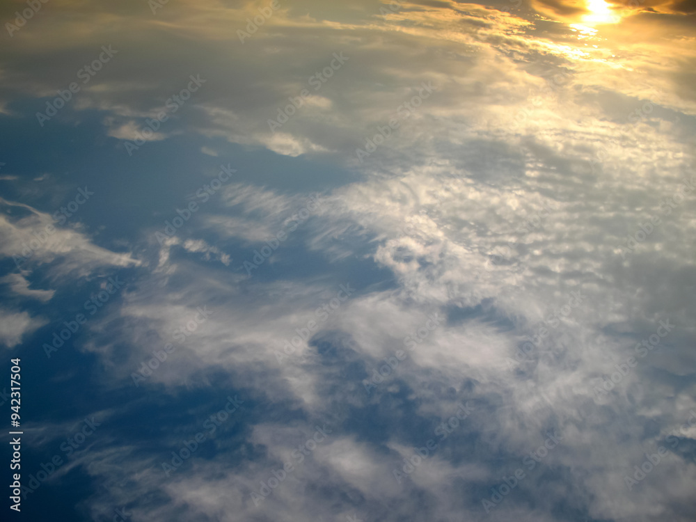 Fototapeta premium clouds at sunset with yellow sun