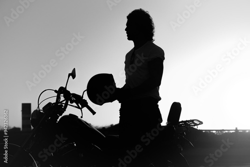 silhouette of a person in a motorbike sunset