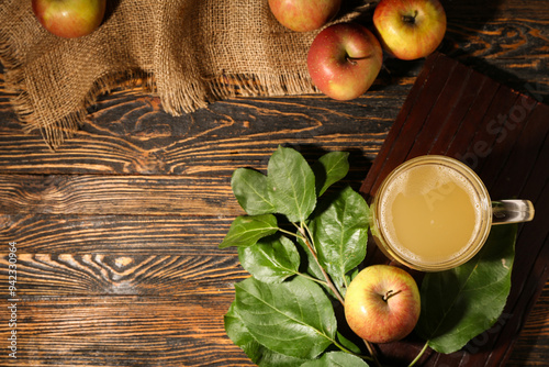 Glass of fresh apple kvass and fruits on wooden background photo