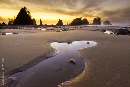 USA, Washington State, Olympic National Park. Sunrise on coast beach and rocks. 