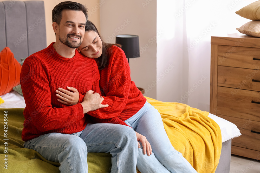 Young couple hugging in bedroom on autumn day Young couple hugging in bedroom on autumn day