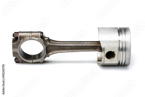 Studio photography of a piston with connecting rod with shadow isolated on a white background. Close-up shot of a new car engine spare part. 