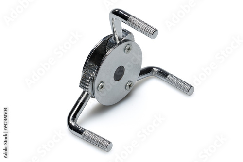 Studio photography of a three legged adjustable oil filter wrench isolated on a white background. Side view, close-up shot of automobile spare parts for passenger cars and light trucks.